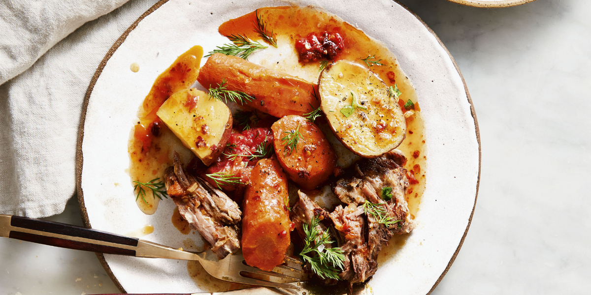 vegetable pot roast with potatoes on a plate with a fork and knife