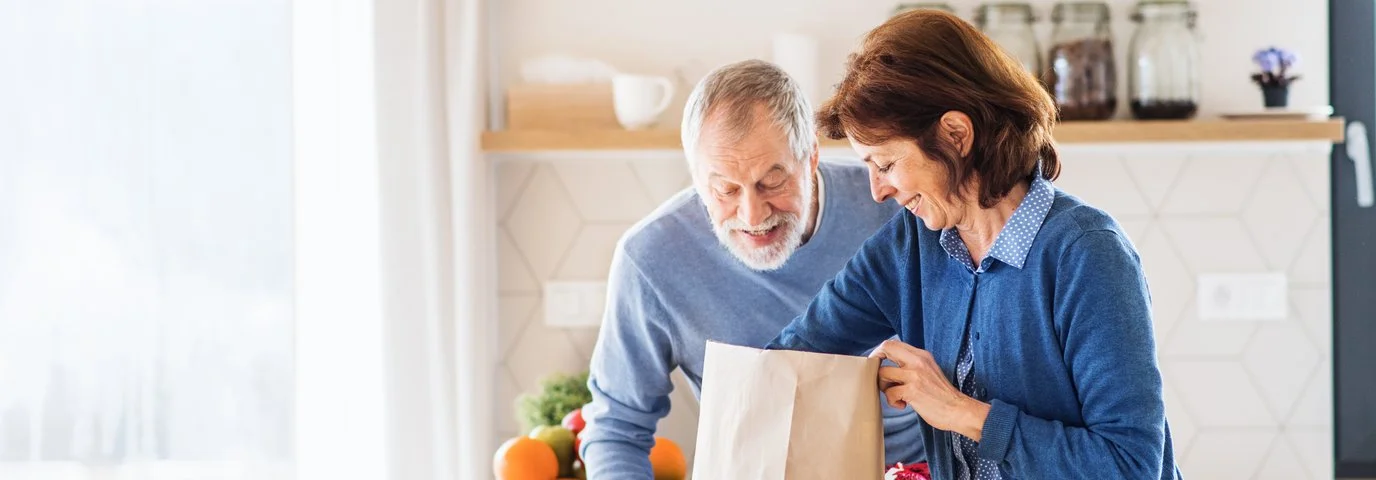 A couple unpacking groceries.