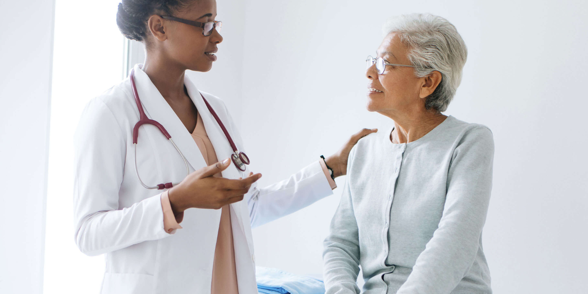 Doctor with a senior patient in an examining room.